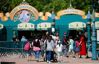 PARIS, FRANCE - JULY 13: People with annual passes wearing protective face masks arrive to visit Disneyland Paris on July 13, 2020 in Marne-la-Vallee, near Paris, France. After four months of closure, the amusement park officially reopens its doors on Wednesday July 15 with compulsory reservations online. The Disneyland Paris and Walt Disney studio parks have been closed since mid-March due to the coronavirus epidemic (COVID 19). (Photo by Chesnot/Getty Images)