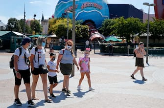 PARIS, FRANCE - JULY 13: People with annual passes wearing protective face masks arrive to visit Disneyland Paris on July 13, 2020 in Marne-la-Vallee, near Paris, France. After four months of closure, the amusement park officially reopens its doors on Wednesday July 15 with compulsory reservations online. The Disneyland Paris and Walt Disney studio parks have been closed since mid-March due to the coronavirus epidemic (COVID 19). (Photo by Chesnot/Getty Images)