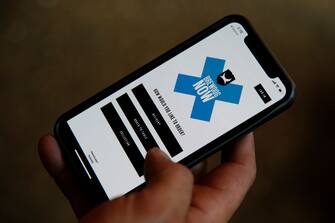 1224562771 LONDON, ENGLAND - JULY 03: A BrewDog Tower Hill staff member demonstrates how to use their app as they prepare to reopen tomorrow with social distancing measures in place on Friday July 3, 2020 in London, England. After being shuttered for months due to the Covid-19 pandemic, pubs and restaurants, many of which have already been serving for take-away, can fully reopen as of July 4. (Photo by Hollie Adams/Getty Images)