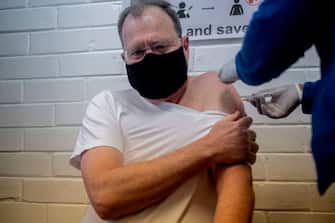 Professor Martin Veller (L), the Dean of the Faculty of Health Sciences at the University of the Witwatersrand (Wits University), receives  an experimental vaccine for COVID-19 coronavirus at the Respiratory & Meningeal Pathogens Research Unit (RMPRU) at Chris Hani Baragwanath Hospital in Soweto on July 14, 2020. - Six senior clinicians in the Faculty of Health Sciences at Wits University have volunteered to participate in South Africas first COVID-19 vaccine trial. (Photo by Luca Sola / AFP) (Photo by LUCA SOLA/AFP via Getty Images)