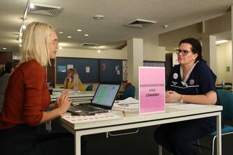1219848351 PERTH, AUSTRALIA - APRIL 20: Registered nurse Heather Hoppe is is screened by a clinic staff member prior to receiving a BCG injection in the trial clinic at Sir Charles Gairdner hospital on April 20, 2020 in Perth, Australia. Healthcare workers in Western Australia are participating in a new trial to test whether an existing tuberculosis vaccine can help reduce their chances of contracting COVID-19. 2000 frontline staff from Fiona Stanley, Sir Charles Gairdner and Perth Children's Hospital are taking part in the research trial, which will see half of participants receiving the existing Bacillus Calmette-Guérin (BCG) vaccine in addition to their flu vaccine, while the other half receive the regular flu shot. The BCG vaccine was originally developed to work against tuberculosis, but it is hoped it might help reduce the chance of contracting coronavirus as well as lessen the severity of symptoms and boost immunity in the long term. The BRACE trial is being led by by the Murdoch Children's Research Institute. (Photo by Paul Kane/Getty Images)