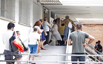 SPAIN PANDEMIC CORONAVIRUS COVID19 epa08549573 Resident wait in a queue outside a primary care center in the district of La Florida, in the city of L'Hospitalet, near Barcelona, Spain, 16 July 2020. Catalan authorities carried out several special measures to avoid the spreading of the virus after a COVID-19 outbreak were registered in three suburbs of L'Hospitalet, the second most populated city of Catalonia. EPA/Alejandro Garcia