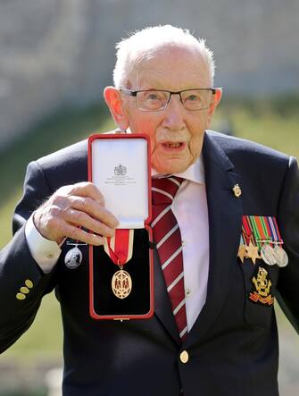 100-year-old WWII veteran Captain Tom Moore poses with his medal after being made a Knight Bachelor during an investiture at Windsor Castle in Windsor, west of London on July 17, 2020. - British World War II veteran Captain Tom Moore was made a a Knight Bachelor (Knighthood) for raising over £32 million for the NHS during the coronavirus pandemic. (Photo by Chris Jackson / POOL / AFP) (Photo by CHRIS JACKSON/POOL/AFP via Getty Images)