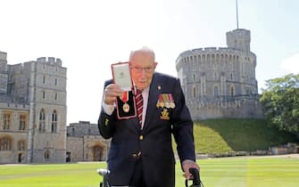 100-year-old WWII veteran Captain Tom Moore poses with his medal after being made a Knight Bachelor during an investiture at Windsor Castle in Windsor, west of London on July 17, 2020. - British World War II veteran Captain Tom Moore was made a a Knight Bachelor (Knighthood) for raising over £32 million for the NHS during the coronavirus pandemic. (Photo by Chris Jackson / POOL / AFP) (Photo by CHRIS JACKSON/POOL/AFP via Getty Images)
