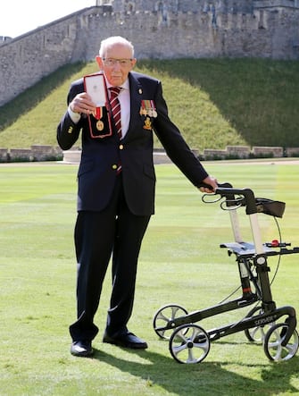 1256704733 WINDSOR, ENGLAND - JULY 17: Captain Sir Thomas Moore poses after being awarded with the insignia of Knight Bachelor by Queen Elizabeth II at Windsor Castle on July 17, 2020 in Windsor, England. British World War II veteran Captain Tom Moore raised over £32 million for the NHS during the coronavirus pandemic. (Photo by Chris Jackson/Getty Images)