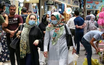 Iranian women wearing protective gear amid the COVID-19 pandemic, shop at the Tajrish Bazaar market in the capital Tehran on July 14, 2020. (Photo by ATTA KENARE / AFP) (Photo by ATTA KENARE/AFP via Getty Images)