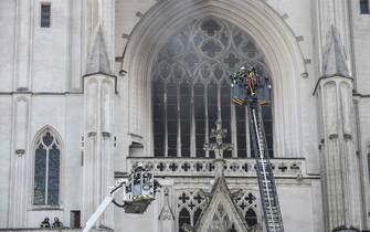 Firefighters are at work to put out a fire at the Saint-Pierre-et-Saint-Paul cathedral in Nantes, western France, on July 18, 2020. - The major fire that broke out on July 18, 2020 inside the cathedral in the western French city of Nantes has now been contained, emergency services said. It is a major fire," the emergency operations centre said, adding that crews were alerted just before 08:00 am (0600 GMT) and that 60 firefighters had been dispatched. (Photo by Sebastien SALOM-GOMIS / AFP) (Photo by SEBASTIEN SALOM-GOMIS/AFP via Getty Images)