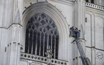 Firefighters are at work to put out a fire at the Saint-Pierre-et-Saint-Paul cathedral in Nantes, western France, on July 18, 2020. - The major fire that broke out on July 18, 2020 inside the cathedral in the western French city of Nantes has now been contained, emergency services said. It is a major fire," the emergency operations centre said, adding that crews were alerted just before 08:00 am (0600 GMT) and that 60 firefighters had been dispatched. (Photo by Sebastien SALOM-GOMIS / AFP) (Photo by SEBASTIEN SALOM-GOMIS/AFP via Getty Images)