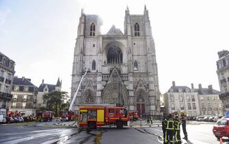 Firefighters are at work to put out a fire at the Saint-Pierre-et-Saint-Paul cathedral in Nantes, western France, on July 18, 2020. - The major fire that broke out on July 18, 2020 inside the cathedral in the western French city of Nantes has now been contained, emergency services said. "It is a major fire," the emergency operations centre said, adding that crews were alerted just before 08:00 am (0600 GMT) and that 60 firefighters had been dispatched. (Photo by Sebastien SALOM-GOMIS / AFP) (Photo by SEBASTIEN SALOM-GOMIS/AFP via Getty Images)