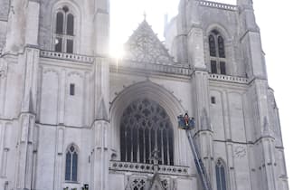 Firefighters are at work to put out a fire at the Saint-Pierre-et-Saint-Paul cathedral in Nantes, western France, on July 18, 2020. - The major fire that broke out on July 18, 2020 inside the cathedral in the western French city of Nantes has now been contained, emergency services said. "It is a major fire," the emergency operations centre said, adding that crews were alerted just before 08:00 am (0600 GMT) and that 60 firefighters had been dispatched. (Photo by Sebastien SALOM-GOMIS / AFP) (Photo by SEBASTIEN SALOM-GOMIS/AFP via Getty Images)