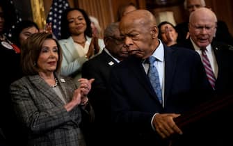 Speaker of the House Nancy Pelosi (D-CA) and others clap for Rep. John Lewis (D-GA) during a press conference about voting rights on Capitol Hill December 6, 2019, in Washington, DC. (Photo by Brendan Smialowski / AFP) (Photo by BRENDAN SMIALOWSKI/AFP via Getty Images)