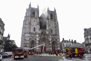Firefighters are at work to put out a fire at the Saint-Pierre-et-Saint-Paul cathedral in Nantes, western France, on July 18, 2020. - A blaze that broke inside the gothic cathedral of Nantes on July 18 has been contained, emergency officials said, adding that the damage was not comparable to last year's fire at Notre-Dame cathedral in Paris. "The damage is concentrated on the organ, which seems to be completely destroyed. Its platform is very unstable and could collapse," regional fire chief General Laurent Ferlay told a press briefing in front of the cathedral. (Photo by Sebastien SALOM-GOMIS / AFP) (Photo by SEBASTIEN SALOM-GOMIS/AFP via Getty Images)
