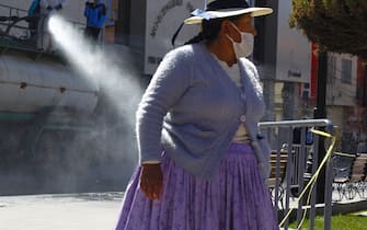 Municipal workers disinfect the main streets of Puno, in the highlands of Peru close to the border with Bolivia, on July 17, 2020 due to an increase of COVID-19 cases - Peru's government has come under heavy criticism for its management of the health crisis, which has left 333,000 people infected, the second most in Latin America, and more than 12,00 dead -- the third highest toll in the region. (Photo by Carlos MAMANI / AFP) (Photo by CARLOS MAMANI/AFP via Getty Images)