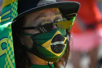 BRASILIA, BRAZIL - JULY 19: Â Supporter of Brazilian President Jair Bolsonaro wears a face mask with the Brazilian flag during a protest amidstÂ the coronavirus (COVID-19) pandemic at the Esplanada dos MinistÃ©rios on July 19, 2020 in Brasilia. Brazil has over 2.070,000 confirmed positive cases of Coronavirus and has over 78,772 deaths. (Photo by Mateus Bononi/Getty Images)