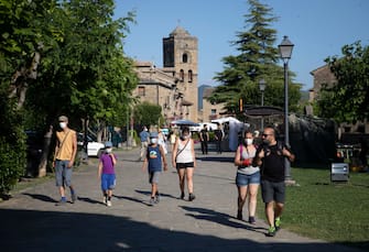 AINSA, SPAIN - JULY 19: Several tourists walk through the town of Ainsa on July 19, 2020 in Ainsa, Spain. The use of masks is mandatory throughout the community of Aragon to stop the spread of the coronavirus (COVID-19). (Photo by Alvaro Calvo /Getty Images)