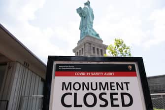 NEW YORK, NY - JULY 20: A closed sign is posted in front of the Statue of Liberty as Liberty Island reopened on July 20, 2020 in New York City. Liberty Island is partially reopening months after the attraction was shut down due to the coronavirus pandemic. Access to Liberty Island has reopened but the statue itself, the pedestal and museum remain closed. (Photo by Jeenah Moon/Getty Images)
