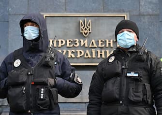Policemen wearing masks guard Ukrainian President Volodymyr Zelensky office in Kiev during the mass rally of veterans with Russia-backed separatists called "No surrender" at Zelensky's office in Kiev on March 14, 2020. - Participants rally despite the ban on holding mass events because of the coronavirus, demanding President Zelensky's resignation. (Photo by Sergei SUPINSKY / AFP) (Photo by SERGEI SUPINSKY/AFP via Getty Images)
