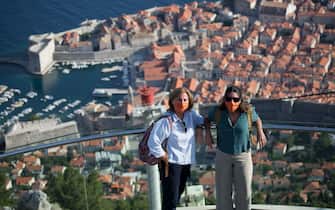 Tourists with protective masks stay on cable car upper station above the old town of Dubrovnik, on July  13, 2020, as the country faces shortage of tourists amid the crisis linked with the Covid-19 pandemic caused by the novel coronavirus. (Photo by Ivan VUKOVIC / AFP) (Photo by IVAN VUKOVIC/AFP via Getty Images)
