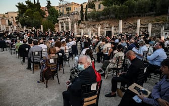 Spectators attend a concert organised by the Greek National Opera at the ancient Roman Agora in Athens on July 18, 2020. - Following long months of coronavirus lockdown that has left music venues, opera houses and concert halls silent across the globe, the Greek National Opera has invited Georgian opera star Anita Rachvelishvili to perform a recital to a small selected audience at the Roman Agora, a unique archeological site dating back to 19 BC. It will also be livestreamed on the opera house's website to music lovers around the world. (Photo by Aris MESSINIS / AFP) (Photo by ARIS MESSINIS/AFP via Getty Images)