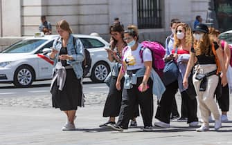 MADRID, SPAIN - JULY 20: Two girls walk through the Puerta del Sol without a mask on July 2, 2020 in Madrid, Spain. Together with the Canary Islands, the Community of Madrid is the only one where it is not yet mandatory to wear a mask. (Photo by David Benito/Getty Images)