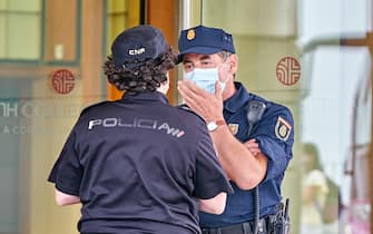 LA CORUNA, SPAIN - JULY 20:  Two policemen speak outside the  Hotel Finisterre place where the CF Fuenlabrada players who have tested positive for Covid-19 are staying, before the La Liga Smartbank match between RC Deportivo and CF Fuenlabrada at Estadio Abanca Riazor on July 20, 2020 in La Coruna, Spain. (Photo by Jose Manuel Alvarez/Quality Sport Images/Getty Images)