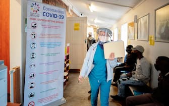 A doctor walks in the Respiratory & Meningeal Pathogens Research Unit (RMPRU) at Chris Hani Baragwanath Hospital in Soweto on July 14, 2020. - Six senior clinicians in the Faculty of Health Sciences at Wits University have volunteered to participate in South Africas first COVID-19 vaccine trial. (Photo by Luca Sola / AFP) (Photo by LUCA SOLA/AFP via Getty Images)