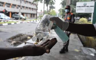 A visitor tries to sanitise hands before being allowed into a state hospital at Yaba in Lagos, on February 28, 2020. - Residents of Nigeria's economic hub Lagos scrambled for hygiene products after the chaotic megacity of 20 million announced the first confirmed case of new coronavirus in sub-Saharan Africa. Health Minister Osagie Ehanire said in a statement overnight that the infected person was an Italian citizen who flew in from Milan, at the heart of Europe's largest outbreak, earlier this week. (Photo by PIUS UTOMI EKPEI / AFP) (Photo by PIUS UTOMI EKPEI/AFP via Getty Images)
