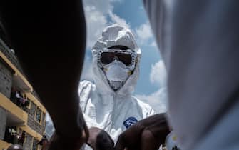TOPSHOT - A health workers puts on a protective gear to disinfect the apartment where the first Kenyan patient of the COVID-19 coronavirus stayed in Ongata Rongai, neighboring town of Nairobi in Kenya, on March 14, 2020. - Kenya announced on March 14, 2020, the first confirmed case of coronavirus in East Africa, as the region so far unscathed by the global pandemic scaled up emergency measures to contain its spread.
A 27-year-old Kenyan woman tested positive for the virus on March 12 in Nairobi, a week after returning from the United States via London. (Photo by Yasuyoshi CHIBA / AFP) (Photo by YASUYOSHI CHIBA/AFP via Getty Images)