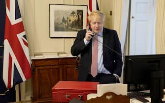1208237311 LONDON, ENGLAND - MARCH 25: Prime Minister Boris Johnson on the telephone to Queen Elizabeth II for her Weekly Audience during the coronavirus (COVID-19) pandemic at 10 Downing Street on March 25, 2020 in London, England. (Photo by Andrew Parsons-WPA Pool/Getty Images)
