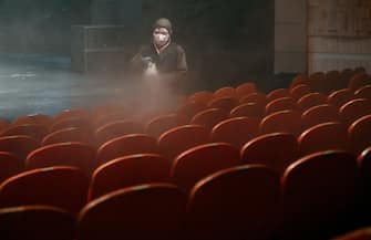 A South Korean worker wearing protective clothes sprays disinfectant in a theatre at Sejong Center in Seoul on July 21, 2020, amid the COVID-19 coronavirus pandemic. (Photo by Jung Yeon-je / AFP) (Photo by JUNG YEON-JE/AFP via Getty Images)