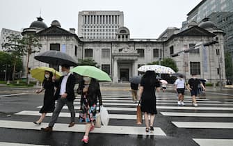 Pedestrians cross the road in front of the Bank of Korea in Seoul on July 23, 2020. - South Korea's economy recorded its worst performance in more than 20 years in the second quarter, the central bank said on July 23, as the coronavirus pandemic hammered its exports. (Photo by Jung Yeon-je / AFP) (Photo by JUNG YEON-JE/AFP via Getty Images)