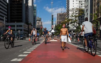1227694933 SAO PAULO, BRAZIL - JULY 19: Cyclists ride in Paulista Avenue bicycle lane amidst the coronavirus (COVID-19) pandemic on July 19, 2020 in Sao Paulo, Brazil. Leisure bike lanes in Sao Paulo returned to operation on weekends after almost a year closed. (Photo by Alexandre Schneider/Getty Images)