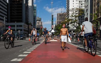 SAO PAULO, BRAZIL - JULY 19: Cyclists ride in Paulista Avenue bicycle lane amidst the coronavirus (COVID-19) pandemic on July 19, 2020 in Sao Paulo, Brazil. Leisure bike lanes in Sao Paulo returned to operation on weekends after almost a year closed. (Photo by Alexandre Schneider/Getty Images)