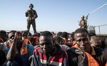 Libyan coast guardsmen stand on a boat during the rescue of 147 illegal immigrants attempting to reach Europe off the coastal town of Zawiyah, 45 kilometres west of the capital Tripoli, on June 27, 2017.
More than 8,000 migrants have been rescued in waters off Libya during the past 48 hours in difficult weather conditions, Italy's coastguard said on June 27, 2017. / AFP PHOTO / Taha JAWASHI (Photo credit should read TAHA JAWASHI/AFP via Getty Images)