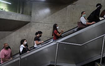 epa08570683 A group of people climb an escalator, in Sao Paulo, Brazil, 28 July 2020. To date, Brazil is close to 90 thousand deaths from the coronavirus.  EPA/Fernando Bizerra