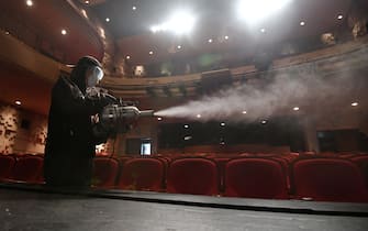 A South Korean worker wearing protective clothes sprays disinfectant in a theatre at Sejong Center in Seoul on July 21, 2020, amid the COVID-19 coronavirus pandemic. (Photo by Jung Yeon-je / AFP) (Photo by JUNG YEON-JE/AFP via Getty Images)