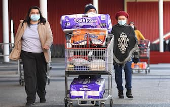 1227877079 People push their trolleys outside a Costco outlet in Melbourne on August 2, 2020 as shoppers queue for provision with the Victorian state government expected to annouce harsh new restrictions due to the city battling fresh outbreaks of the COVID-19 coronavirus. (Photo by William WEST / AFP) (Photo by WILLIAM WEST/AFP via Getty Images)