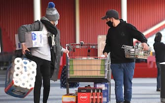 1227876917 People push their trolleys outside a Costco outlet in Melbourne on August 2, 2020 as shoppers queue for provision with the Victorian state government expected to annouce harsh new restrictions due to the city battling fresh outbreaks of the COVID-19 coronavirus. (Photo by William WEST / AFP) (Photo by WILLIAM WEST/AFP via Getty Images)