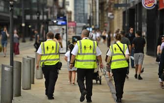 1227857923 Metrolink workers wear high vis jackets with that urge social distancing as a precuation against the transmission of the novel coronavirus in Manchester, northwest England, on July 31, 2020. - Britain today "put the brakes on" easing lockdown measures and imposed new rules on millions of households in northern England, following concerns over a spike in coronavirus infections. (Photo by Oli SCARFF / AFP) (Photo by OLI SCARFF/AFP via Getty Images)