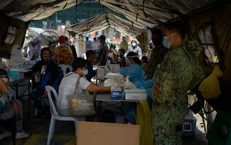 1227783917 MANILA, PHILIPPINES - JULY 26: Police authorites facilitate the processing and COVID-19 testing of thousands of Filipinos wanting to get back home to their provinces amid an increasing rate of COVID-19 infection in the Philippines' capital on July 26, 2020 in Manila, Philippines. Philippines is posed to reimpose lockdowns in areas that are hardest-hit by COVID-19, as cases in the country reached the 80k mark. The Department of Health said there are now 80,448 COVID-19 cases, of which 52,406 are considered as active cases. Last week, President Duterte threatened to have anyone not wearing masks arrested and lockdown violators shot for spreading the virus or causing trouble. Department of Interior Secretary Eduardo Año said police will go house-to-house for COVID-19 patients with mild symptoms, a statement that was later dismissed by the palace as untrue. (Photo by Jes Aznar/Getty Images)