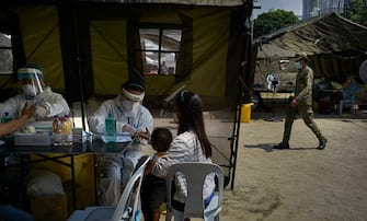 1227783696 MANILA, PHILIPPINES - JULY 26: Police authorites facilitate the processing and COVID-19 testing of thousands of Filipinos wanting to get back home to their provinces amid an increasing rate of COVID-19 infection in the Philippines' capital on July 26, 2020 in Manila, Philippines. Philippines is posed to reimpose lockdowns in areas that are hardest-hit by COVID-19, as cases in the country reached the 80k mark. The Department of Health said there are now 80,448 COVID-19 cases, of which 52,406 are considered as active cases. Last week, President Duterte threatened to have anyone not wearing masks arrested and lockdown violators shot for spreading the virus or causing trouble. Department of Interior Secretary Eduardo Año said police will go house-to-house for COVID-19 patients with mild symptoms, a statement that was later dismissed by the palace as untrue. (Photo by Jes Aznar/Getty Images)