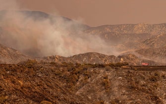 A lone fire truck drives through a charred landscape during the Apple fire in Banning, California on August 02, 2020. - More than 1,300 firefighters were battling a blaze that was burning out of control August 2 in southern California, threatening thousands of people and homes east of Los Angeles.
The so-called Apple Fire that broke out Friday near the city of San Bernardino has so far charred more than 20,000 acres (8,000 hectares), sending up columns of smoke visible from far away. (Photo by JOSH EDELSON / AFP) (Photo by JOSH EDELSON/AFP via Getty Images)