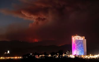 Morongo Casino scrolls gambling messages across the building as the Apple fire burns further into national forest territory in Cabazon, California on August 2, 2020. - More than 1,300 firefighters were battling a blaze that was burning out of control August 2 in southern California, threatening thousands of people and homes east of Los Angeles.
The so-called Apple Fire that broke out Friday near the city of San Bernardino has so far charred more than 20,000 acres (8,000 hectares), sending up columns of smoke visible from far away. (Photo by JOSH EDELSON / AFP) (Photo by JOSH EDELSON/AFP via Getty Images)