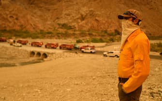 Whitewater Preserve Manager Kerry Puckett watches as firefighters arrive at the scene of a new start about 20 miles from the Apple fire in Whitewater, California on August 2, 2020. - Puckett says the fire started out of nowhere and immediately grew out of control due to high heat, wind and low humidity. (Photo by JOSH EDELSON / AFP) (Photo by JOSH EDELSON/AFP via Getty Images)