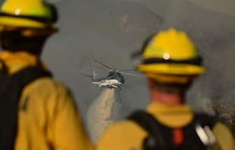 A helicopter drops water on hot spots during the Apple fire near Banning, California on August 1, 2020. - 4,125 acres have burn in Cherry Valley, about 2,000 people have received evacuation orders in the afternoon of August 1. 
Around 8PM the fire spread to 12,000 acres. (Photo by JOSH EDELSON / AFP) (Photo by JOSH EDELSON/AFP via Getty Images)