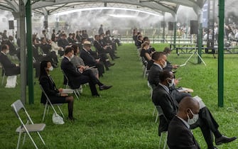 1227930404 HIROSHIMA, JAPAN - AUGUST 06: People sit in socially distanced chairs as a precaution against coronavirus as they as they attend the 75th anniversary of the Hiroshima atomic bombing, on August 6, 2020 in Hiroshima, Japan. In a ceremony that has been scaled back significantly because of Covid-19 coronavirus, Japan will mark the 75th anniversary of the first atomic bomb that was dropped by the United States on Hiroshima on August 6, 1945. The bomb instantly killed an estimated 70,000 people and thousands more in coming years from radiation effects. Three days later the United States dropped a second atomic bomb on Nagasaki which ended World War II. (Photo by Carl Court/Getty Images)