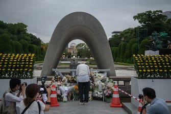 HIROSHIMA, JAPAN - AUGUST 06: A man prays in remembrance at the Hiroshima Victims Memorial Cenotaph ahead of the ceremony to mark the 75th anniversary of the Hiroshima atomic bombing, on August 6, 2020 in Hiroshima, Japan. In a ceremony that has been scaled back significantly because of Covid-19 coronavirus, Japan will mark the 75th anniversary of the first atomic bomb that was dropped by the United States on Hiroshima on August 6, 1945. The bomb instantly killed an estimated 70,000 people and thousands more in coming years from radiation effects. Three days later the United States dropped a second atomic bomb on Nagasaki which ended World War II. (Photo by Carl Court/Getty Images)
