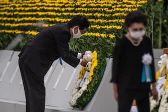 HIROSHIMA, JAPAN - AUGUST 06: Japanese Prime Minister, Shinzo Abe, lays a wreath during the 75th anniversary of the Hiroshima atomic bombing, on August 6, 2020 in Hiroshima, Japan. In a ceremony that has been scaled back significantly because of Covid-19 coronavirus, Japan will mark the 75th anniversary of the first atomic bomb that was dropped by the United States on Hiroshima on August 6, 1945. The bomb instantly killed an estimated 70,000 people and thousands more in coming years from radiation effects. Three days later the United States dropped a second atomic bomb on Nagasaki which ended World War II. (Photo by Carl Court/Getty Images)