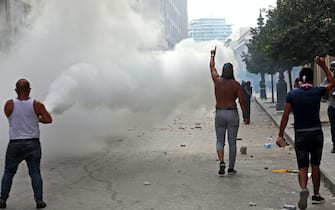 Lebanese protesters gesture towards security forces during clashes in downtown Beirut on October8, 2020, following a demonstration against a political leadership they blame for a monster explosion that killed more than 150 people and disfigured the capital Beirut. (Photo by Anwar AMRO / AFP) (Photo by ANWAR AMRO/AFP via Getty Images)