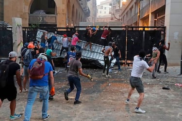 Lebanese protesters, enraged by a deadly explosion blamed on officials' negligence, clash with security forces for the second evening near an access street to the parliament in central Beirut, on August 9, 2020. (Photo by JOSEPH EID / european afp / AFP) (Photo by JOSEPH EID/european afp/AFP via Getty Images)